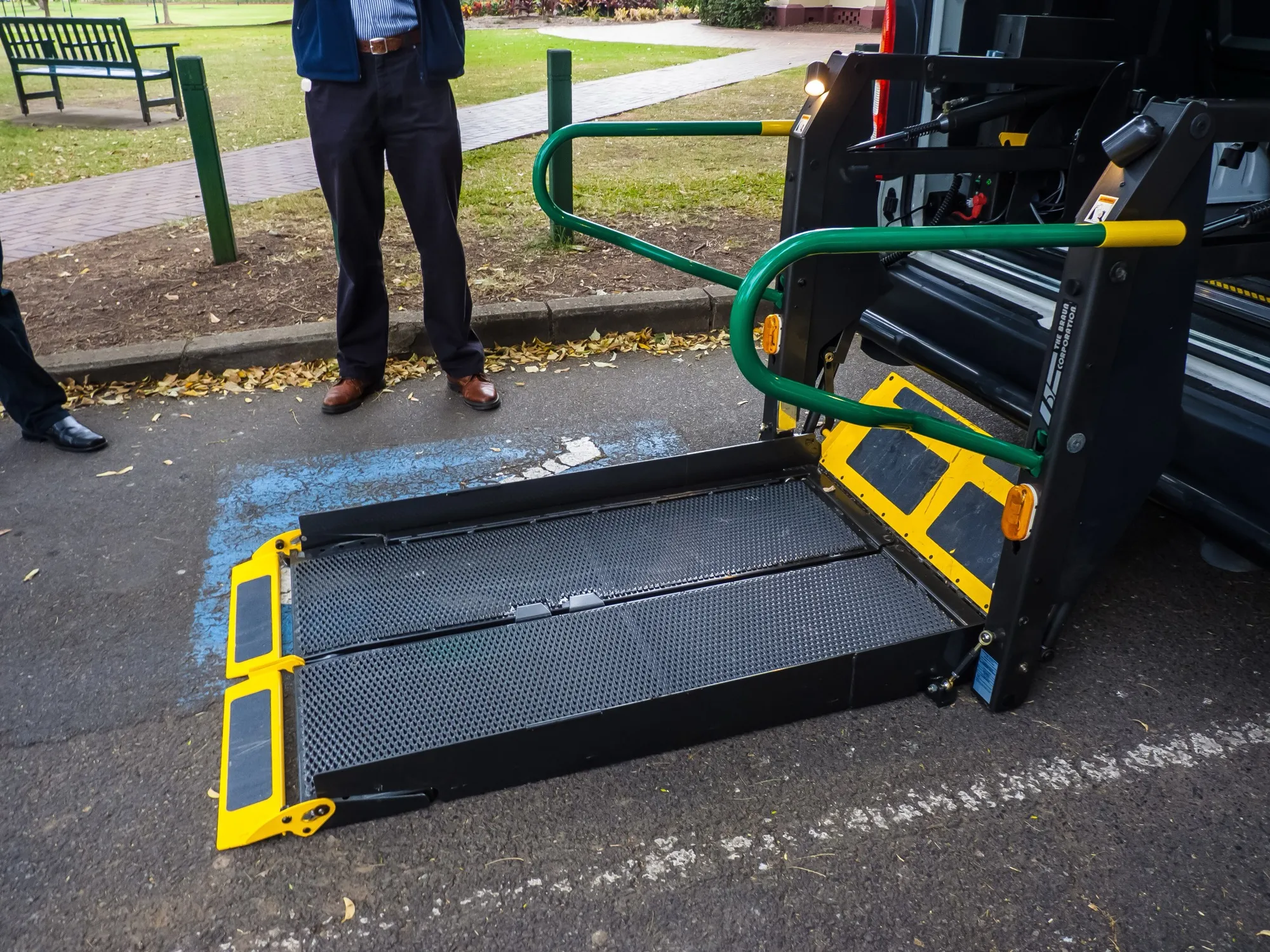 A lowered wheelchair lift platform on an accessible taxi in Brisbane, Australia, shown as an example of a lift vehicle