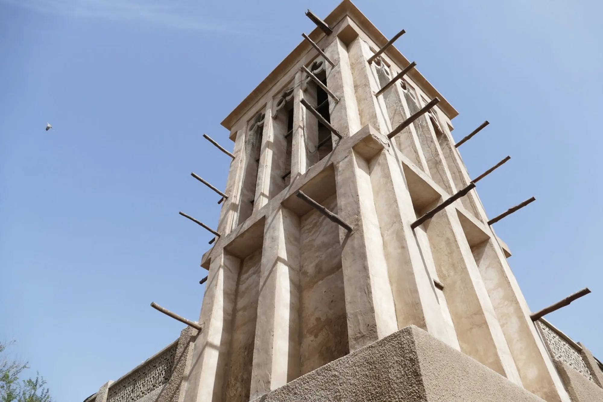 A traditional wind tower rising above a courtyard house in Al Fahidi, Dubai