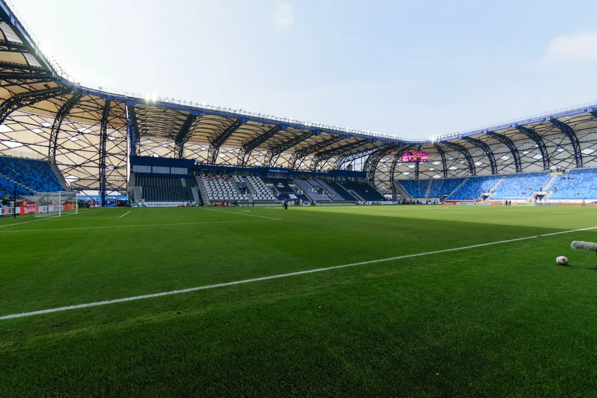 A floodlit match at Al Maktoum Stadium in Dubai, seen from the stands