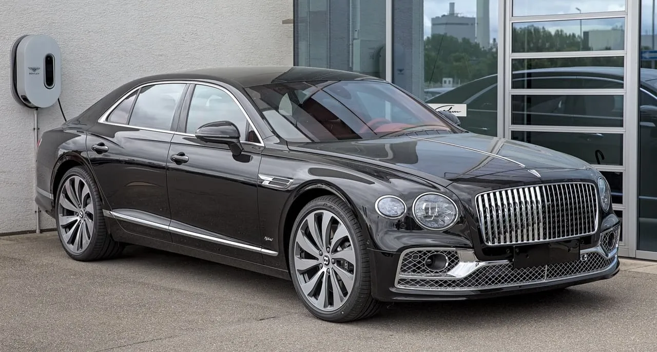 A black Bentley Flying Spur Hybrid sedan, seen from the front