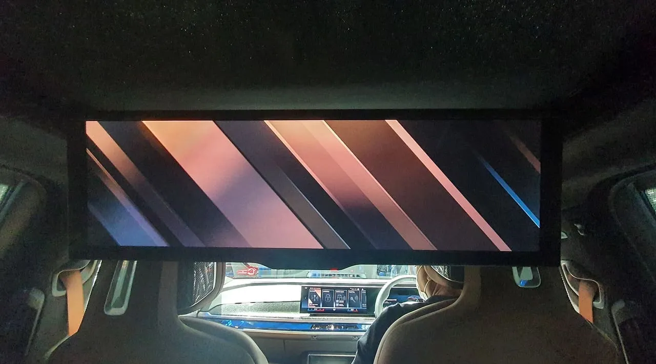 The 31-inch Theatre Screen folded down from the roof of a BMW 7 Series, seen from the rear seat