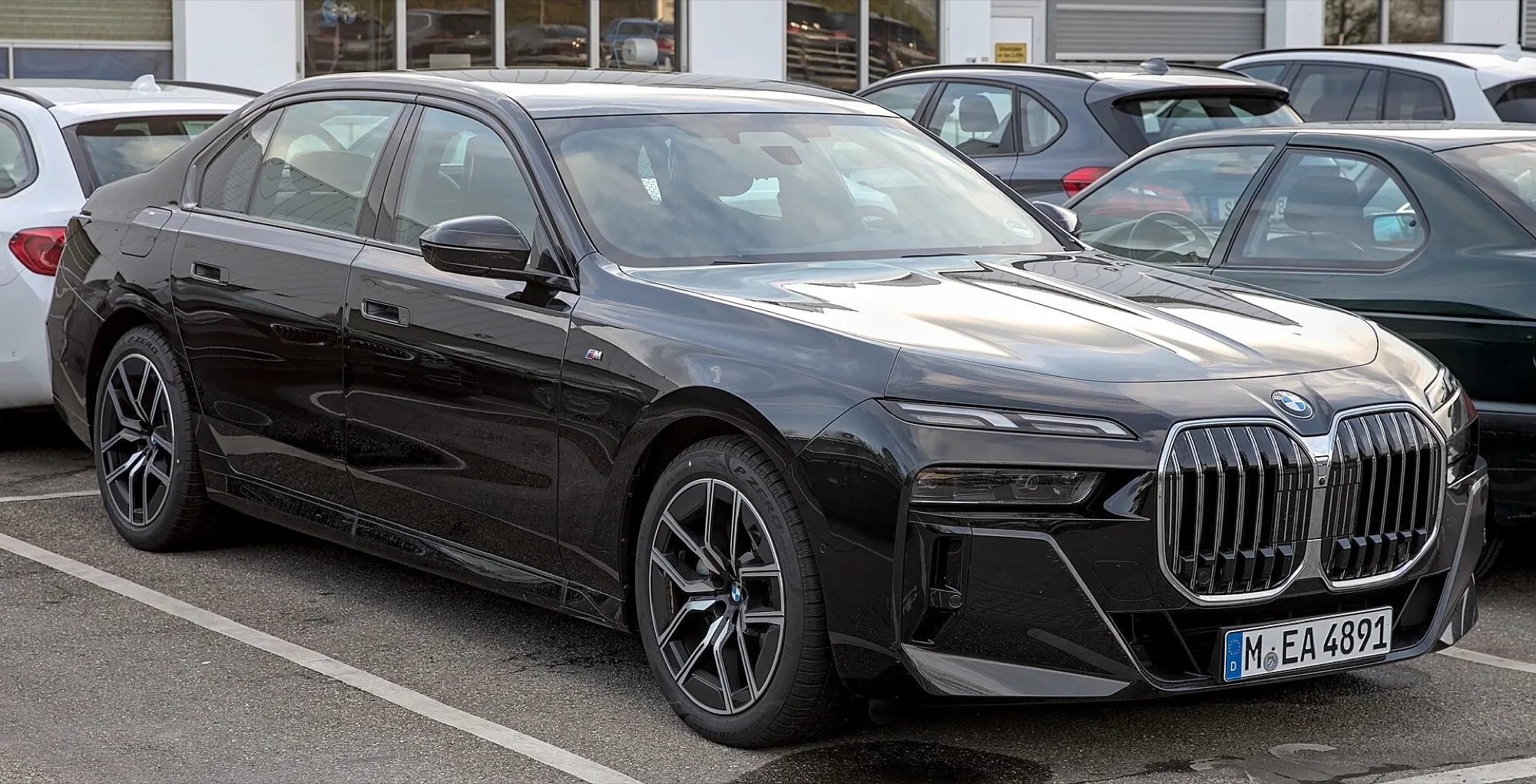 A black BMW 7 Series (G70) saloon seen from the front three-quarter
