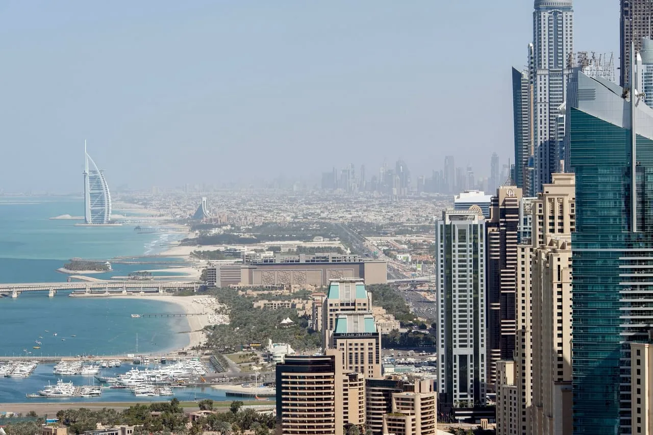 The Burj Al Arab on the Jumeirah coast with the Dubai skyline beyond