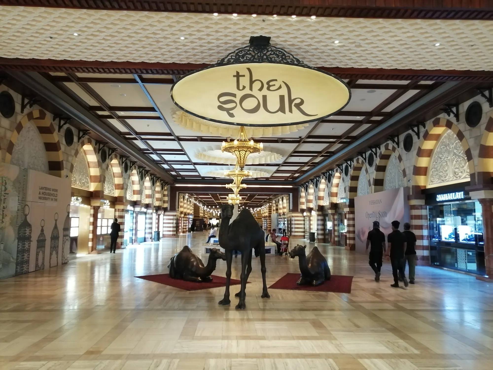 The Souk entrance inside Dubai Mall, with bronze camel statues on the marble floor