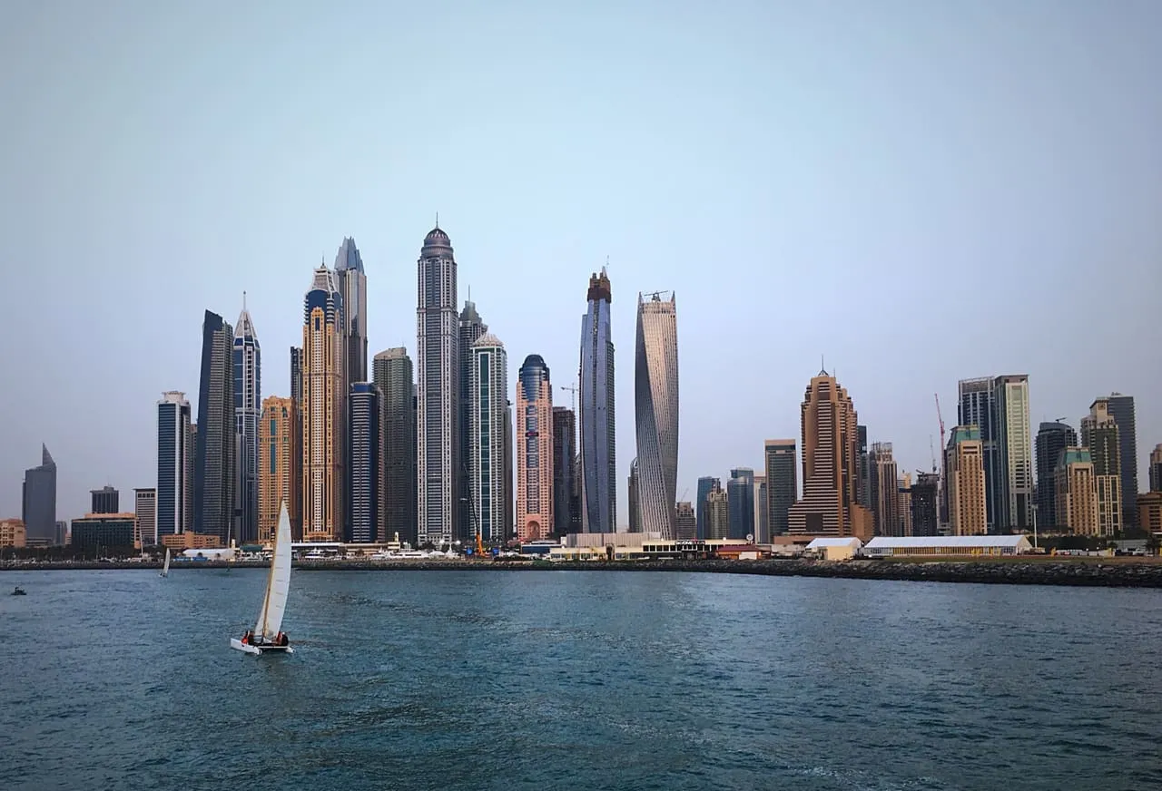 The Dubai Marina skyline, with the twisting Cayan Tower, seen from a boat on the water
