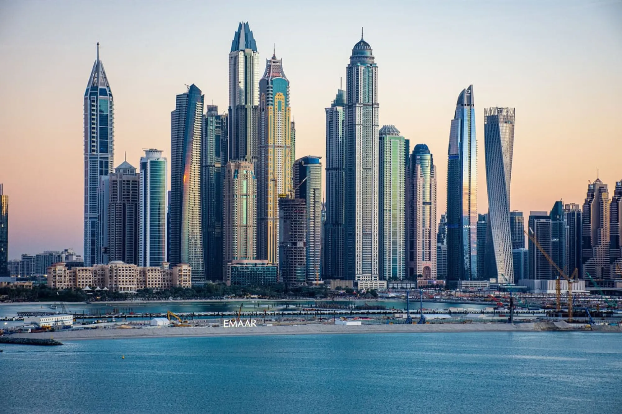 The towers of Dubai Marina at dusk, seen across the water