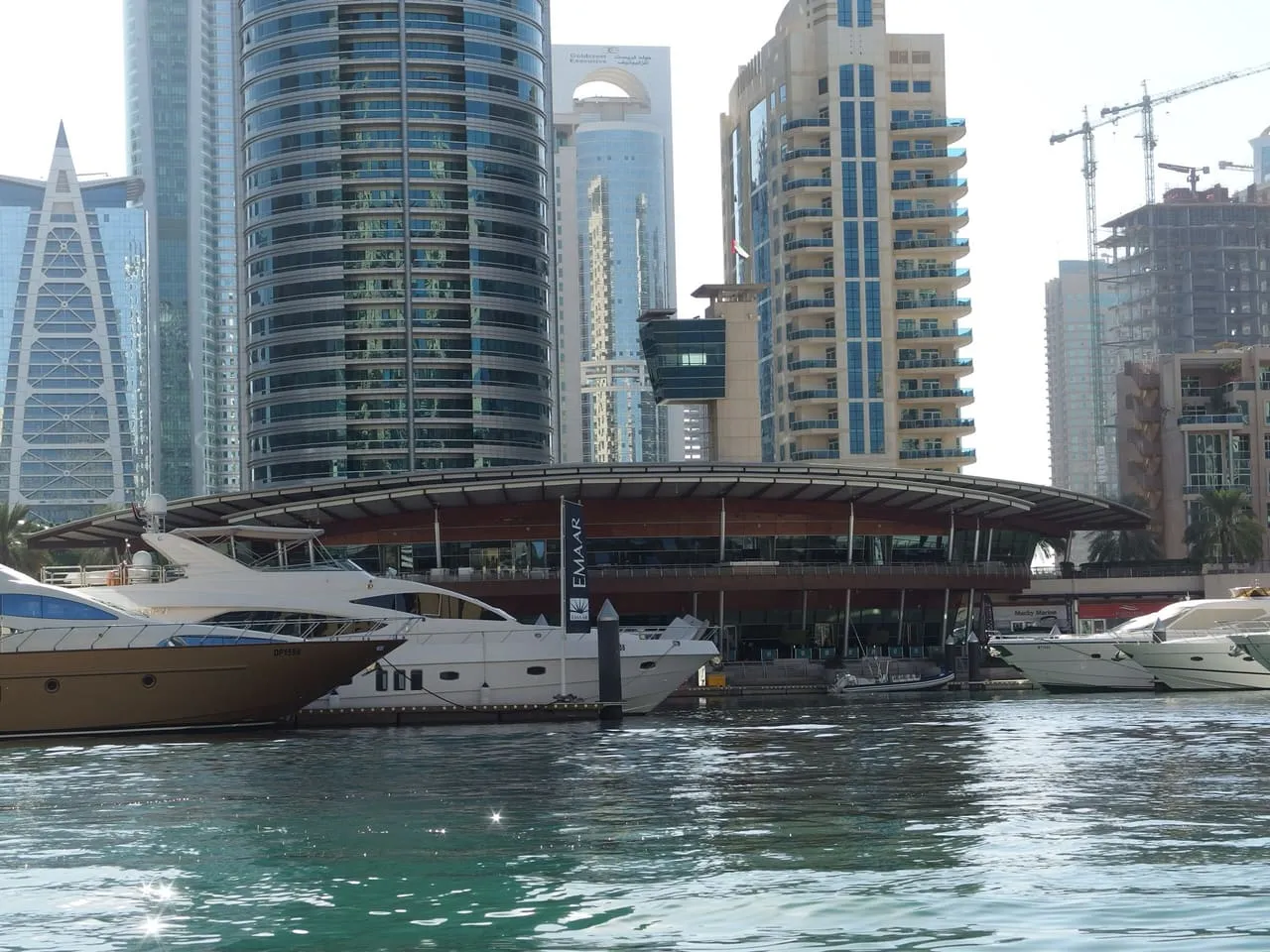 Motor yachts moored at the Dubai Marina Yacht Club below the Marina towers