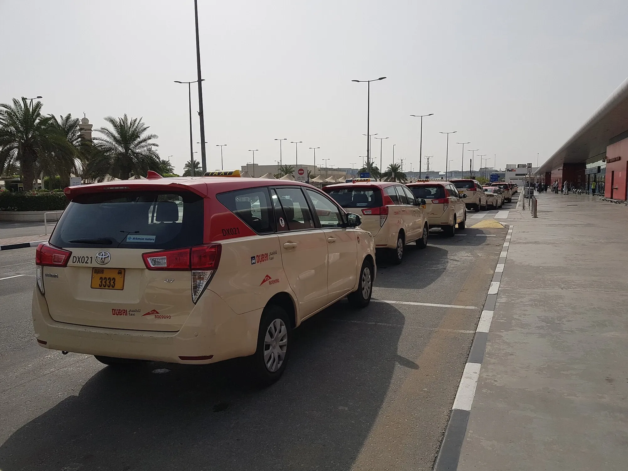 Dubai Taxi cars queuing at the rank outside Terminal 2 at Dubai International