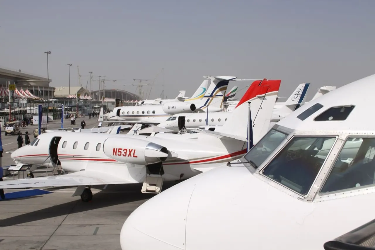 Business jets parked side by side on the apron at Dubai International (DXB)