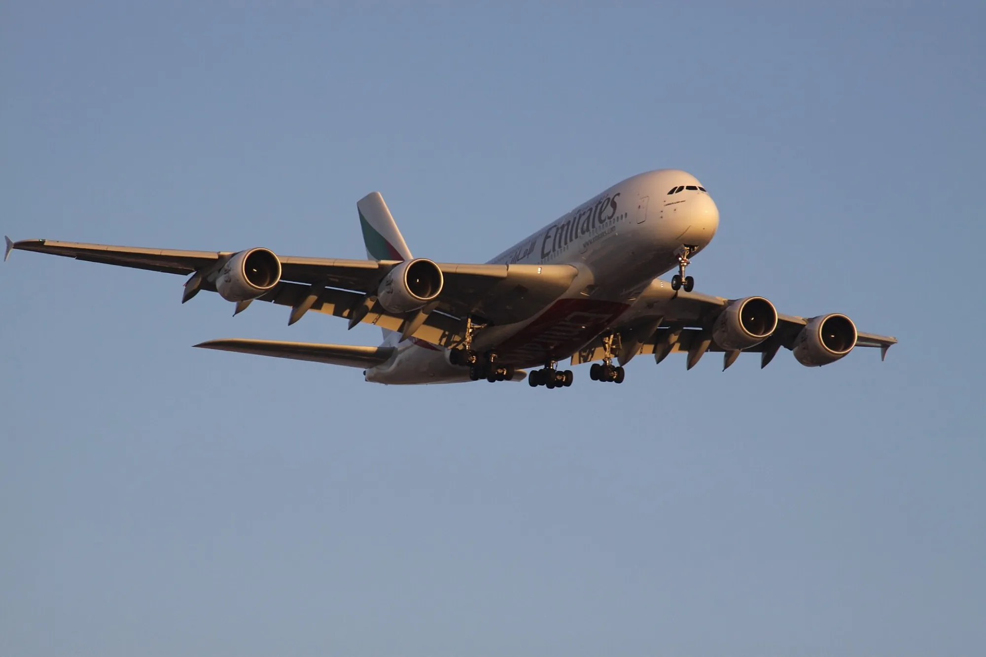 An Emirates Airbus A380 on approach in evening light