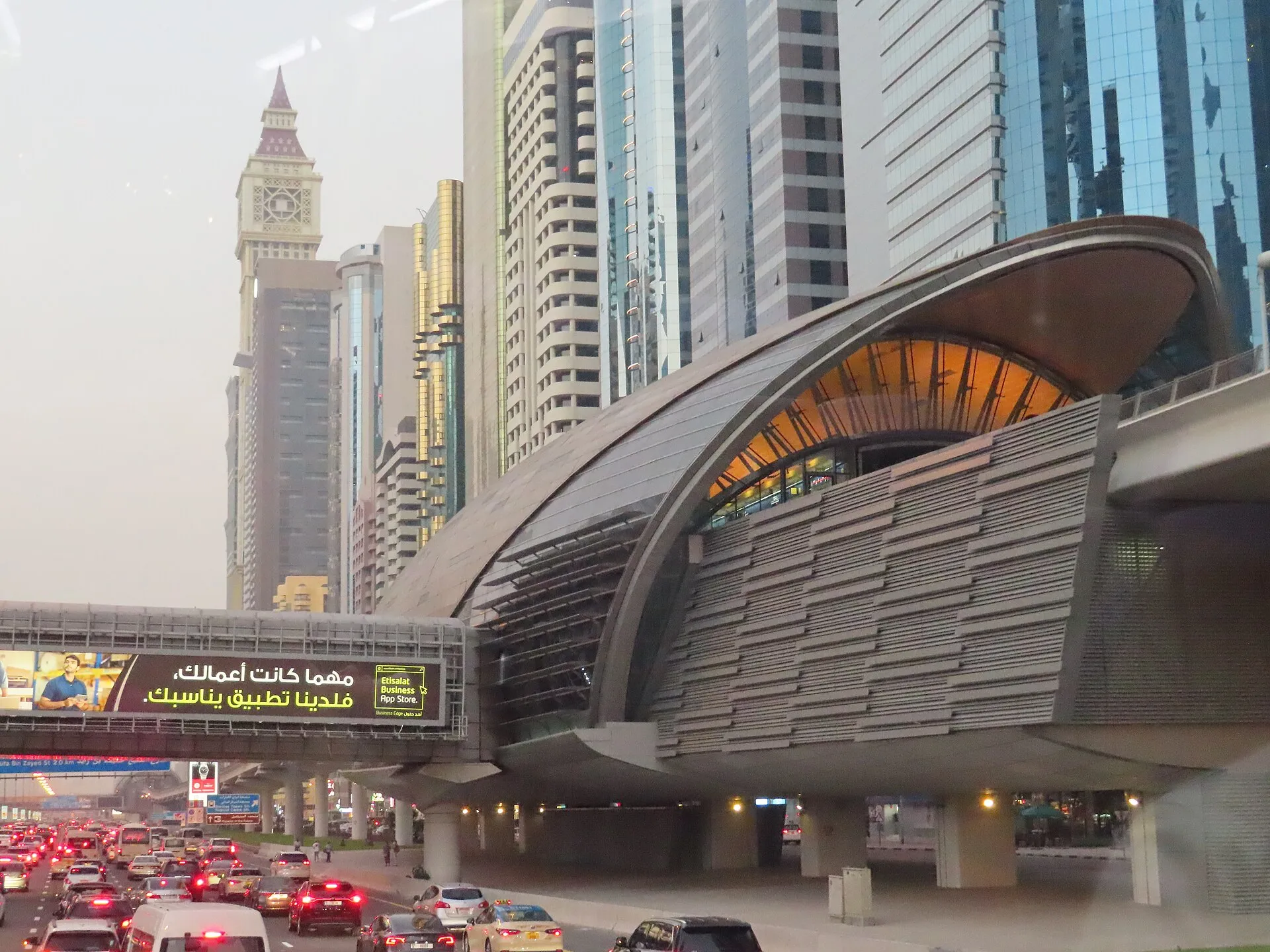 The Financial Centre Metro Station beside Sheikh Zayed Road, with a row of office towers behind and queued traffic below