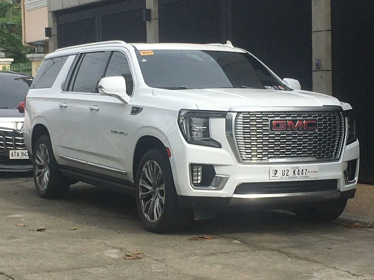 A white GMC Yukon XL Denali, the long-wheelbase version of the Yukon