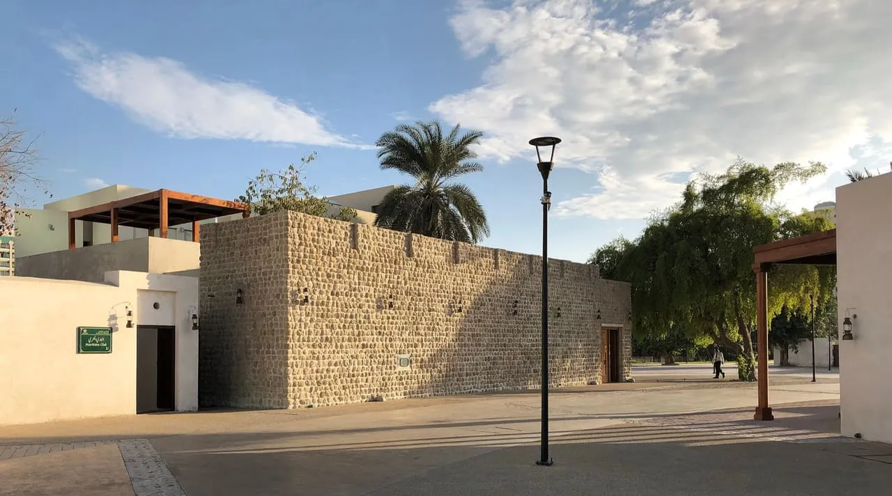 Restored coral-stone buildings and a paved square in the Heart of Sharjah heritage district