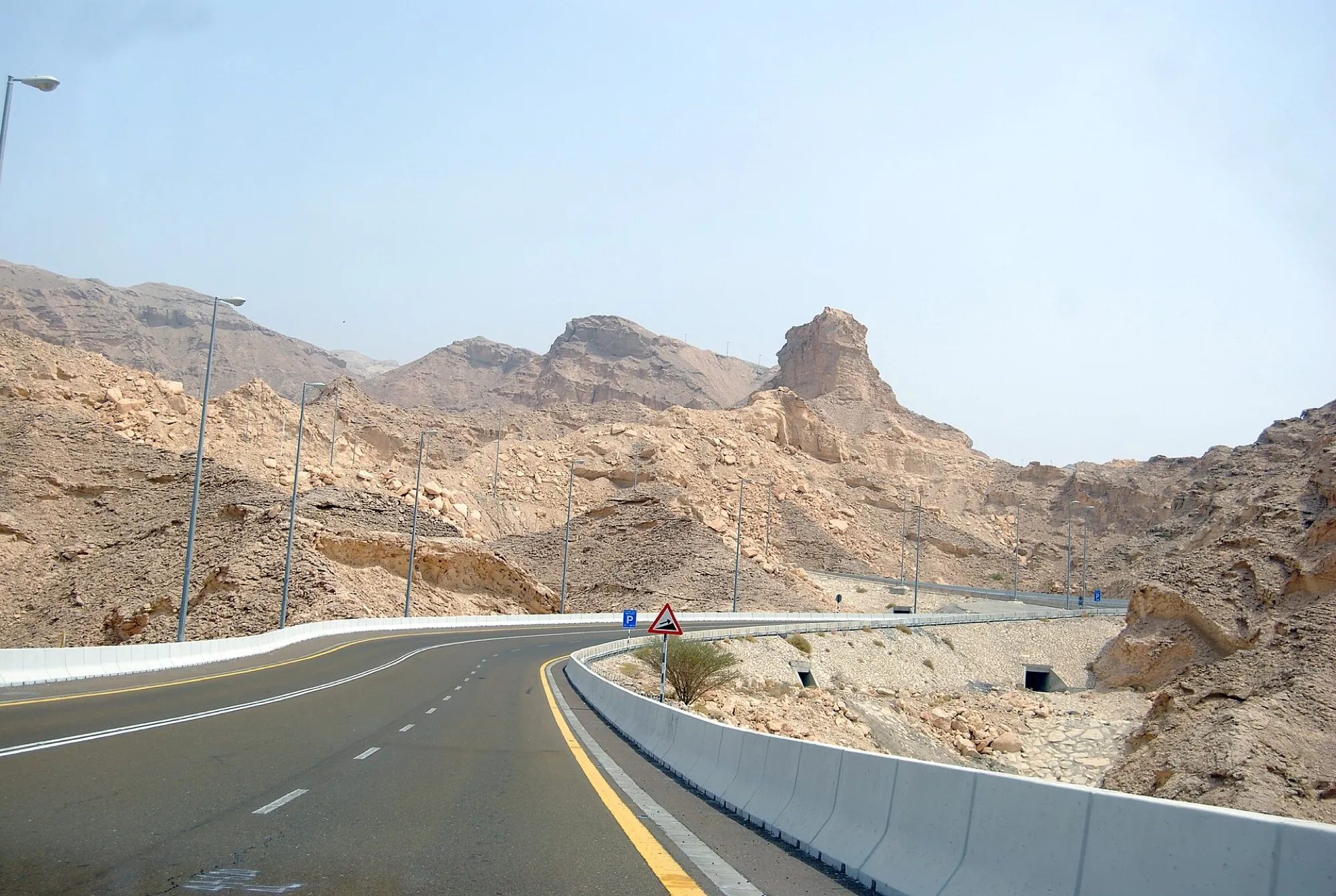 The mountain road up Jebel Hafeet near Al Ain, with crash barriers and rocky hills