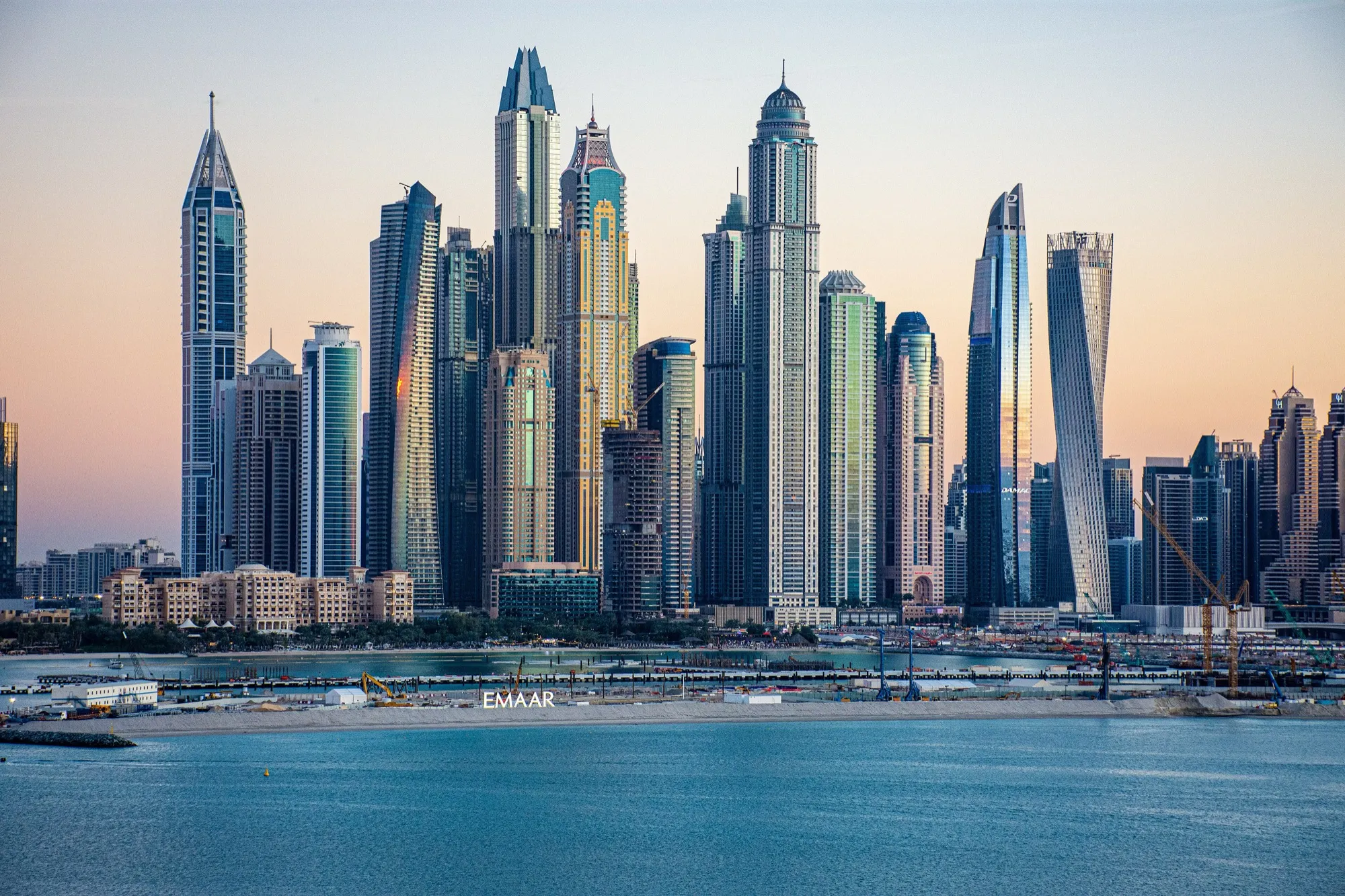 The Dubai Marina towers rising above the marina waterfront at dusk