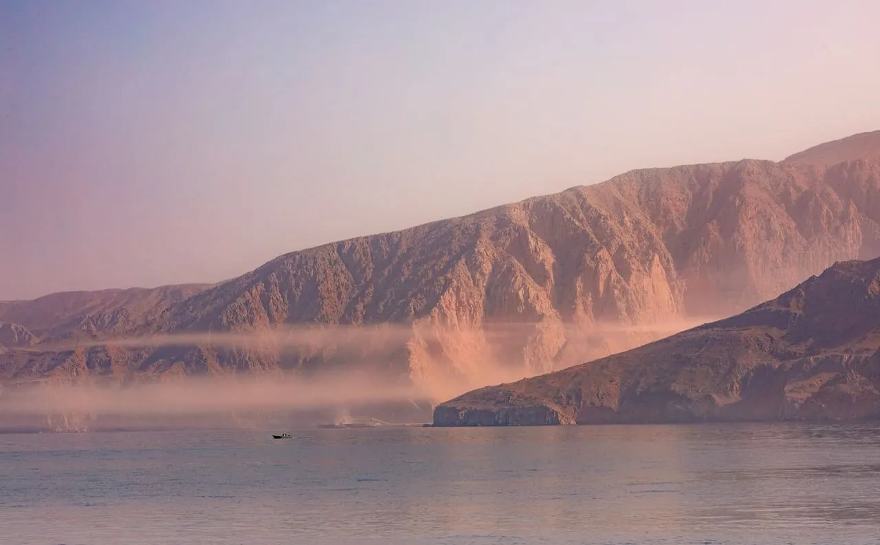 Bare mountains of the Musandam Peninsula rising straight out of the sea in Oman