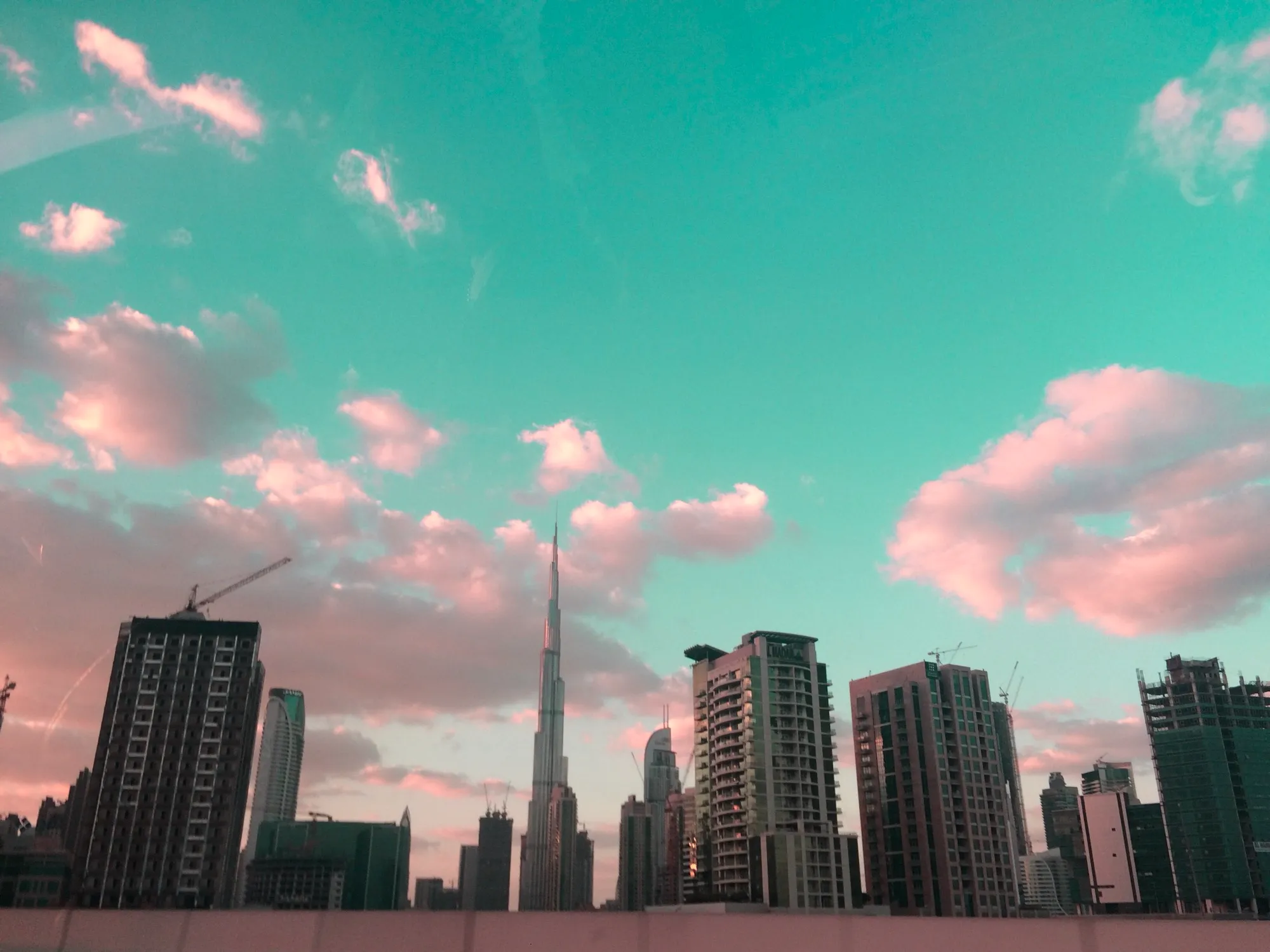 Burj Khalifa rising above Business Bay towers at dusk, Dubai