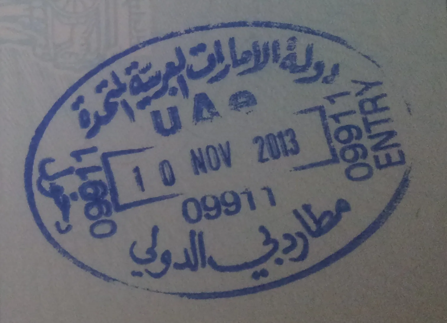A UAE entry stamp from Dubai International Airport in a passport