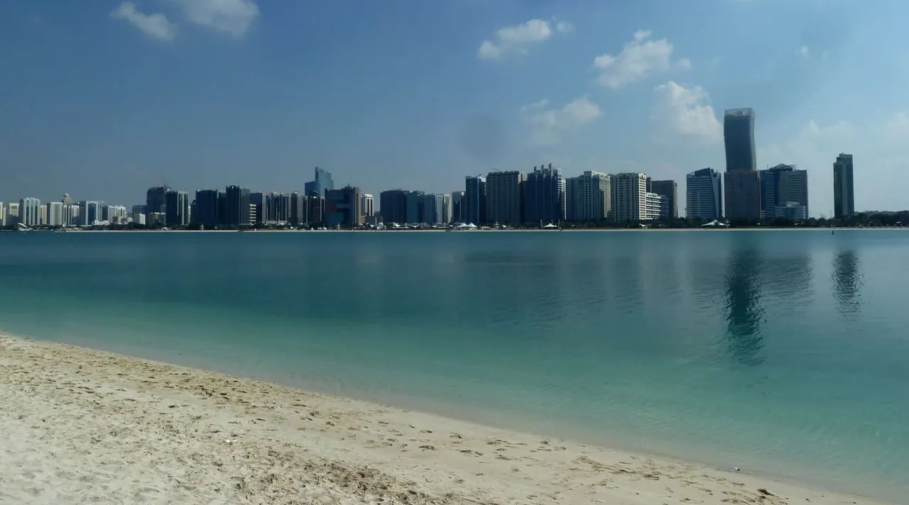 The Corniche beach in Abu Dhabi with the city-centre skyline across the water