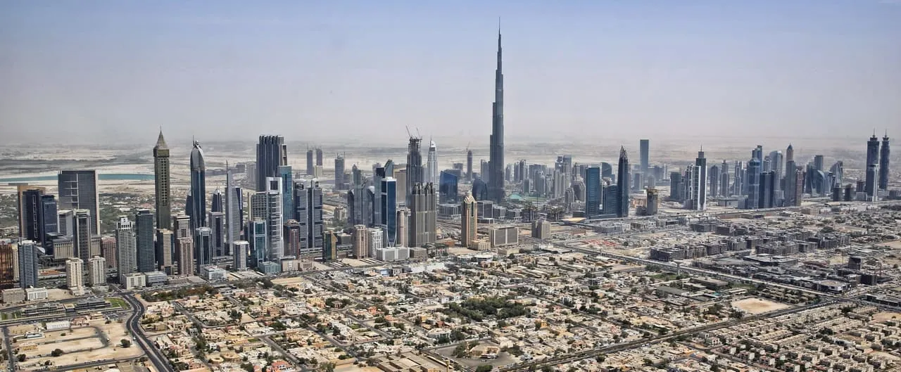 The Dubai skyline with Burj Khalifa, seen from the air above the low-rise neighbourhoods