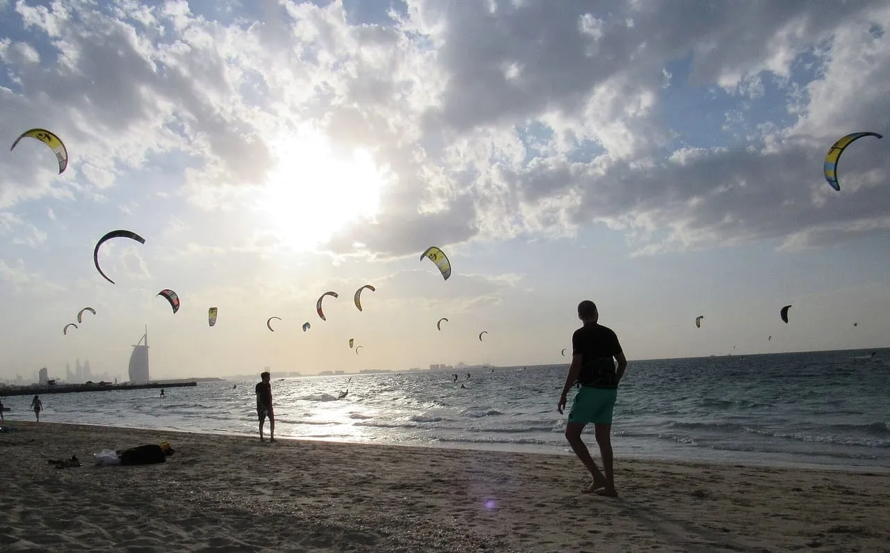 Kitesurfers' kites over the sea at Kite Beach in Jumeirah, with the Burj Al Arab on the horizon