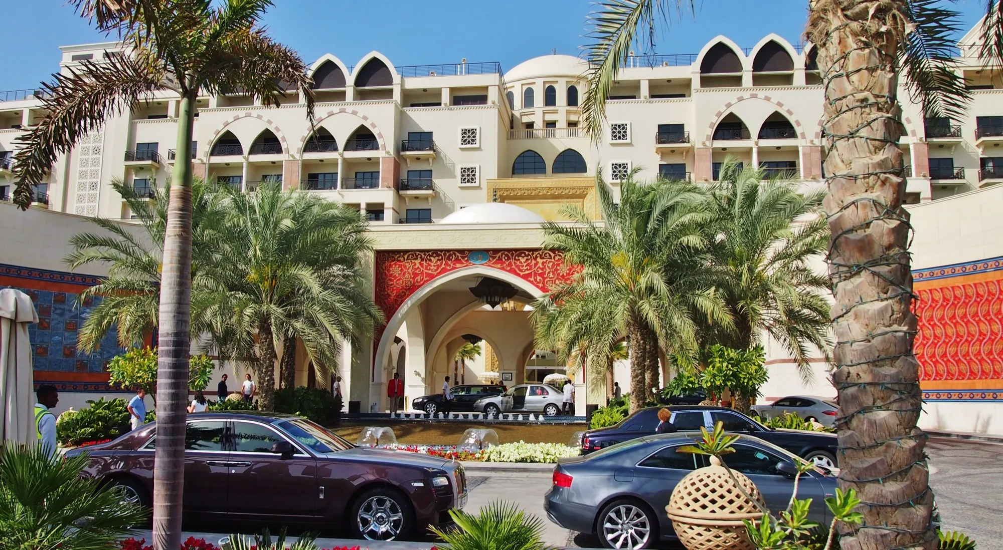 Cars parked in the forecourt by the arched entrance of Jumeirah Zabeel Saray on Palm Jumeirah