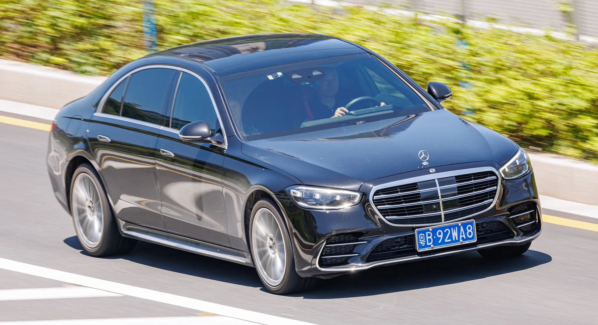 A black Mercedes-Benz S-Class saloon, the kind of car used for executive driver services
