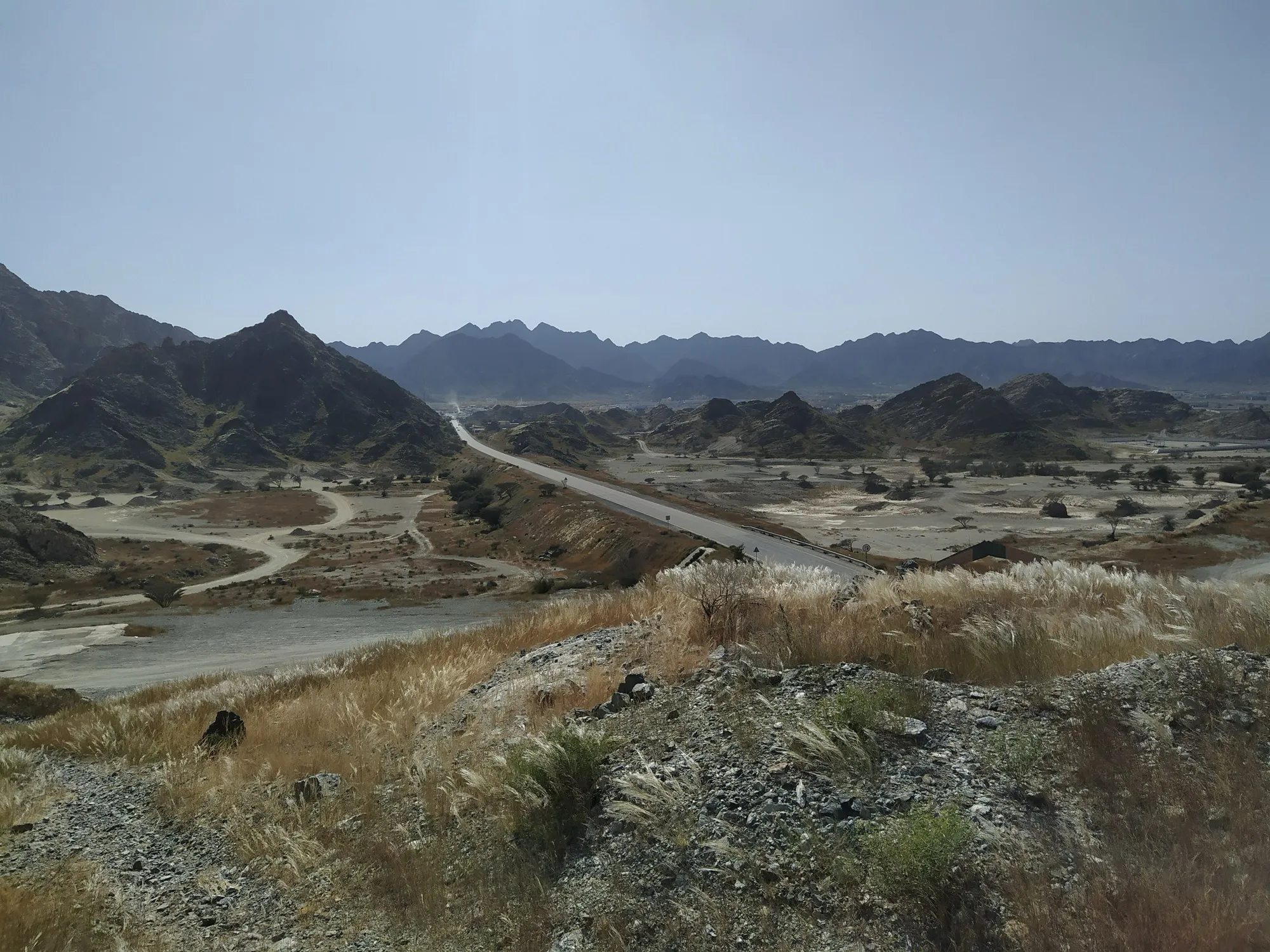 A road winding between the Hajar Mountains on the way to Fujairah