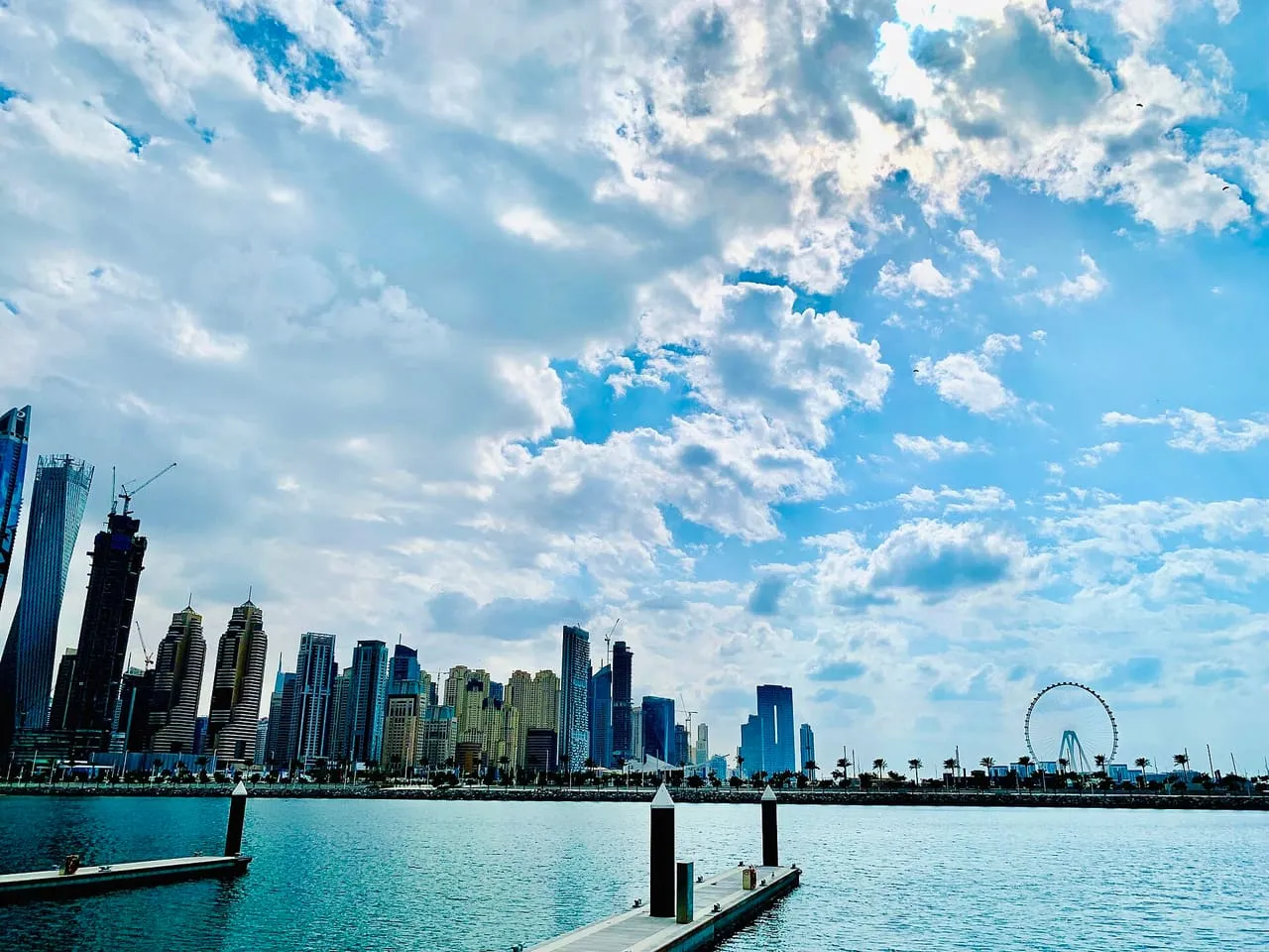Floating pontoons at Dubai Harbour with the JBR skyline and the Ain Dubai wheel across the water