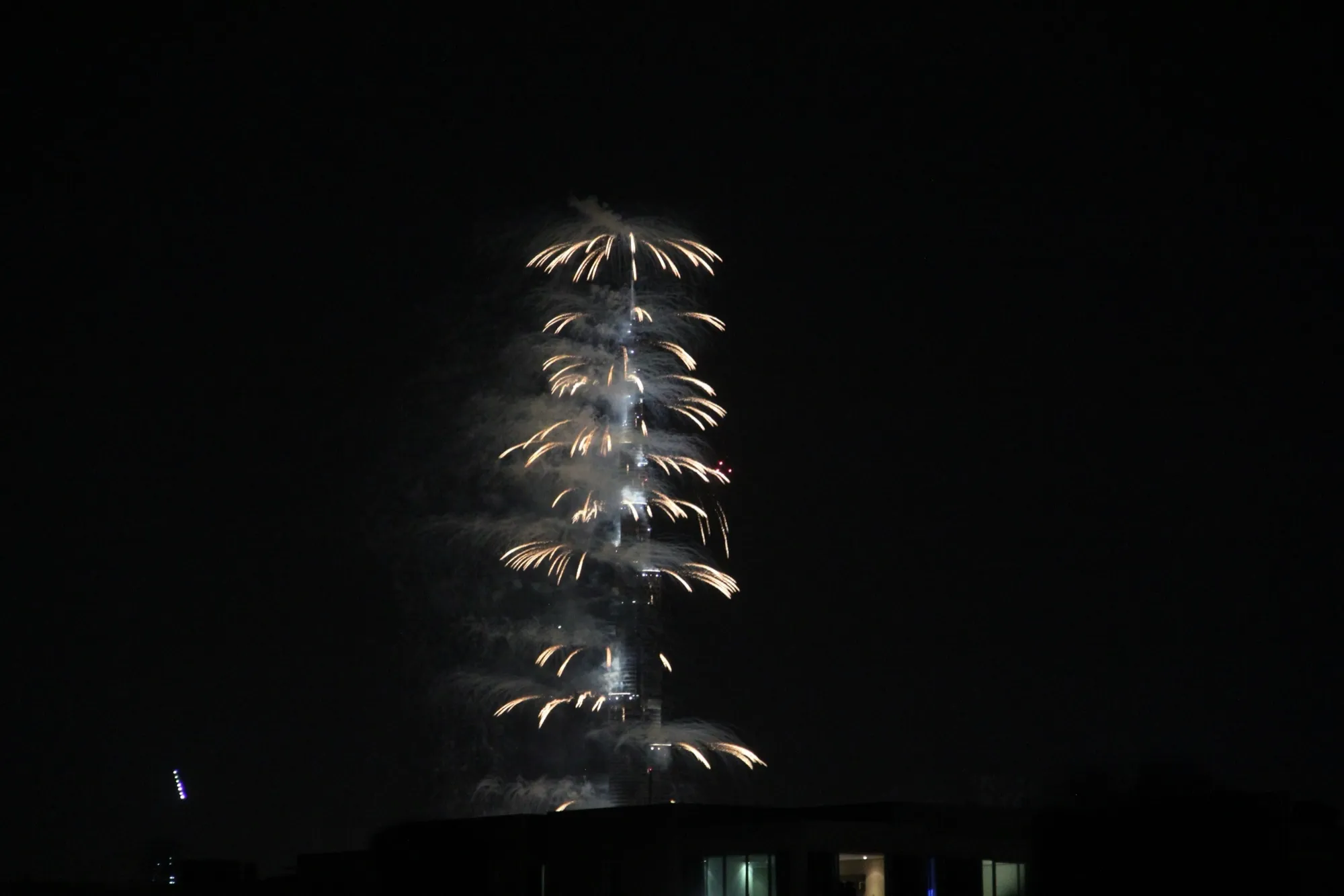 Fireworks bursting down the length of Burj Khalifa at midnight on New Year's Eve in Downtown Dubai
