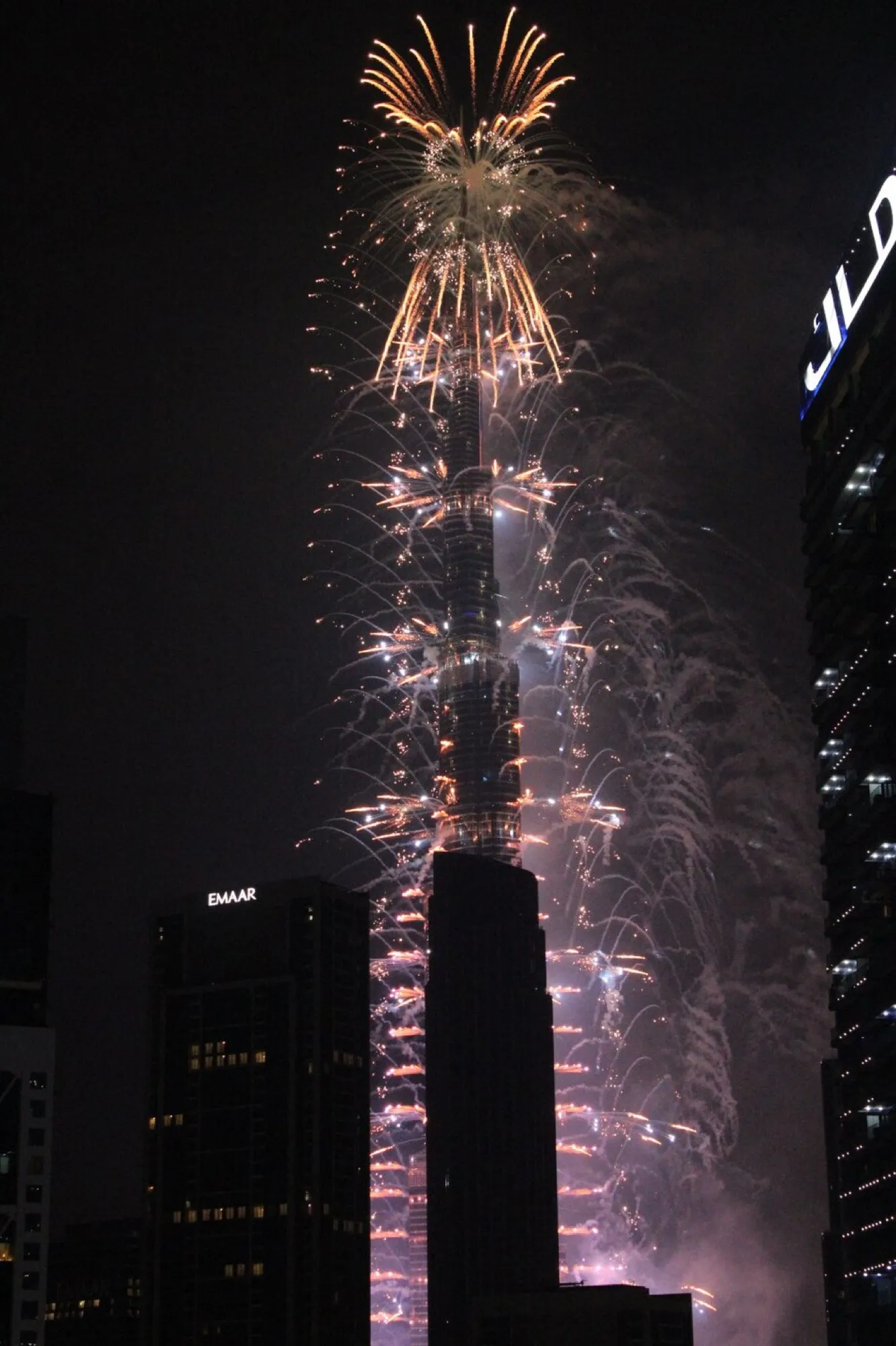 Fireworks cascading down Burj Khalifa at night in Downtown Dubai