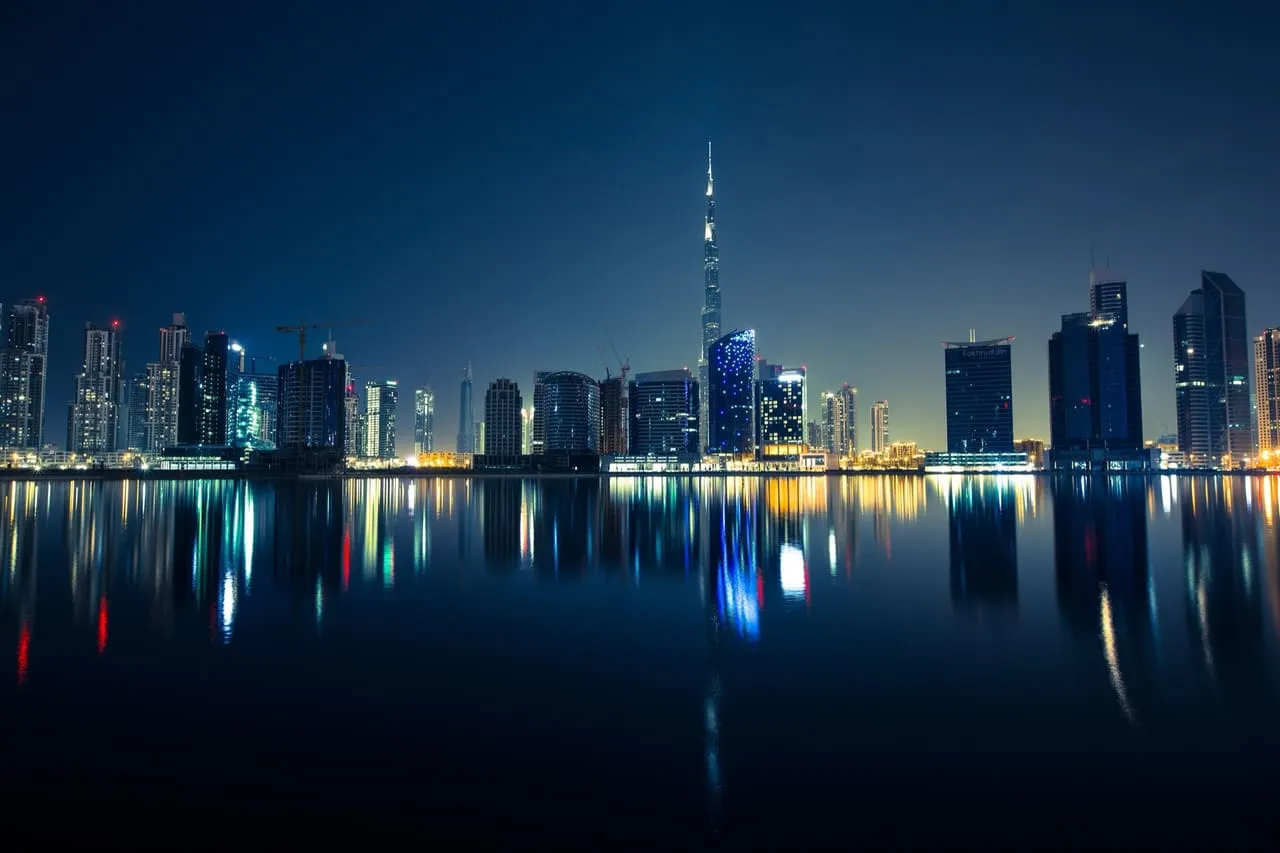 The Business Bay skyline and the Burj Khalifa reflected in the water at night