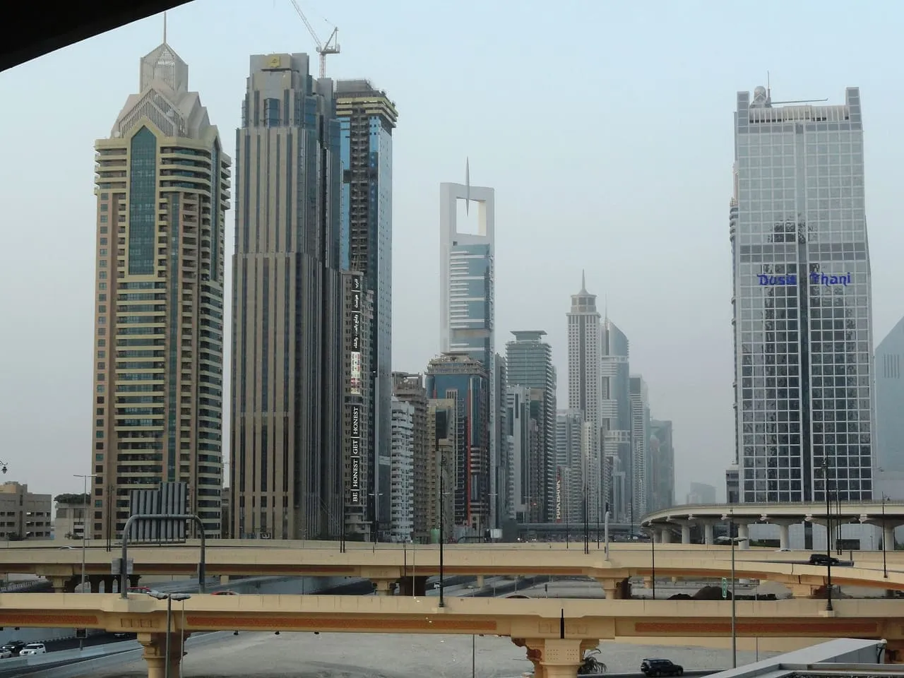 Towers along Sheikh Zayed Road in Dubai rising behind the flyovers of a road interchange