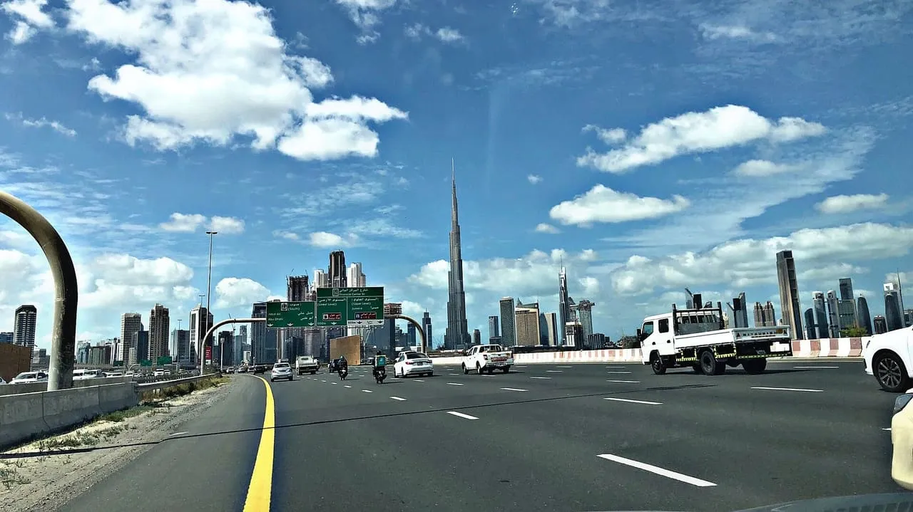 Al Khail Road in Dubai on a clear morning, with Burj Khalifa on the skyline ahead
