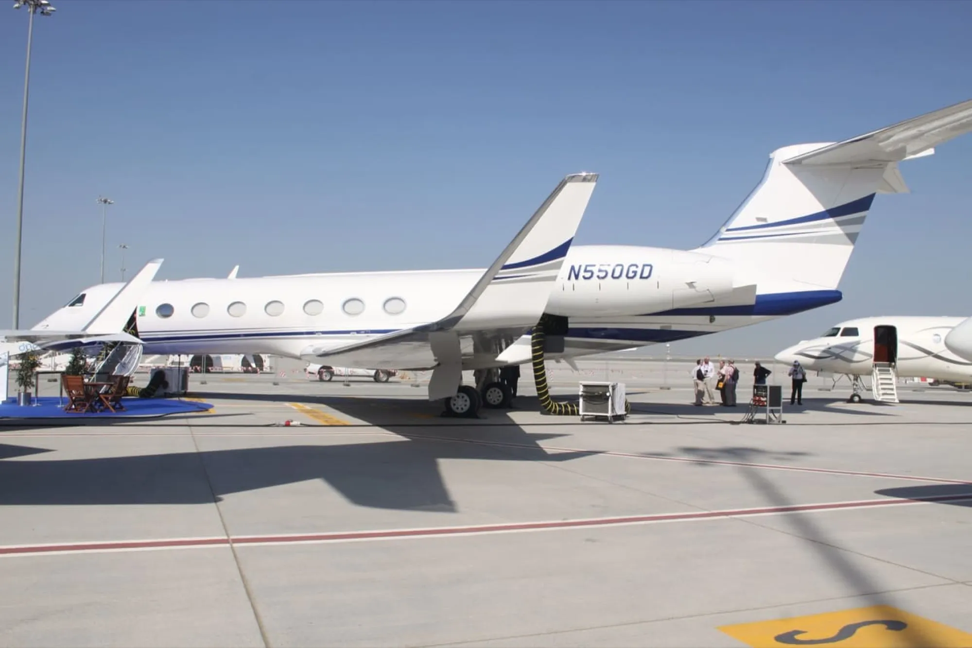 A Gulfstream G550 business jet parked on an airport apron, typical of the aircraft that use Abu Dhabi's executive airport