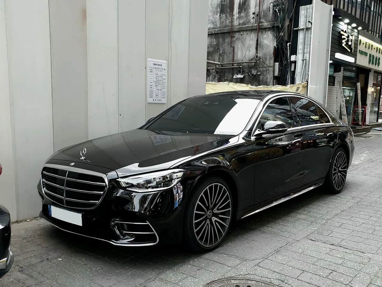 A black Mercedes-Benz S-Class saloon parked at the kerb