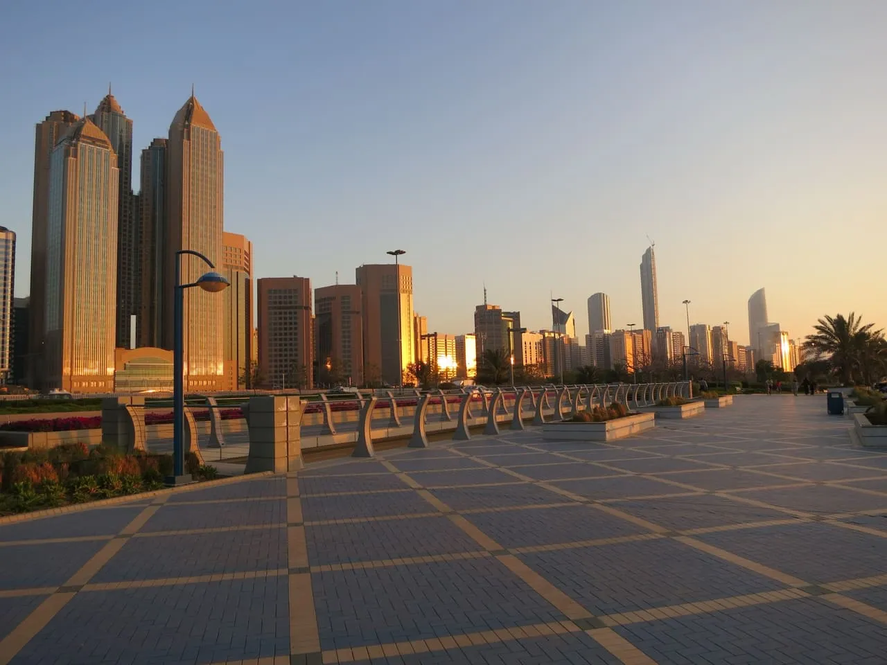 The Abu Dhabi skyline at sunset, seen from the Corniche promenade