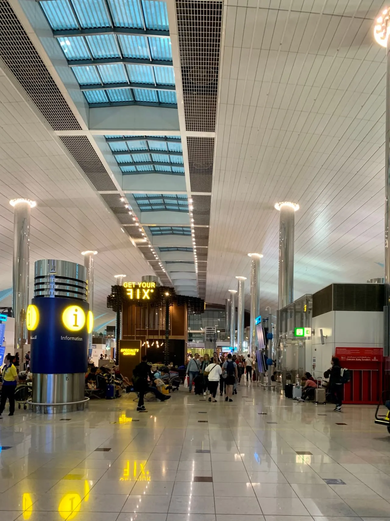 Information point and shops along a Terminal 3 concourse at Dubai International