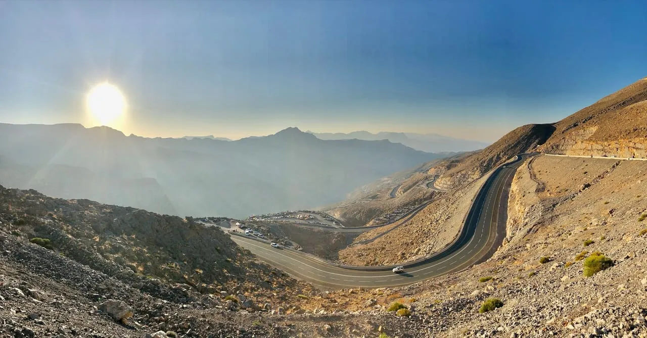 Jais Road curving up the rocky mountainside of Jebel Jais at sunrise on a winter morning