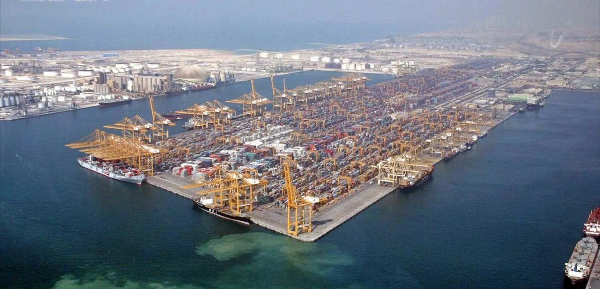 Aerial view of Jebel Ali Port, with container cranes and stacks of containers beside the free zone
