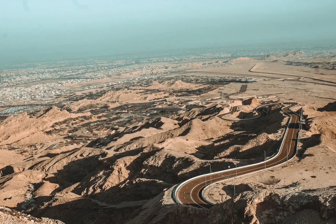 The mountain road winding up Jebel Hafeet, with Al Ain spread across the plain below