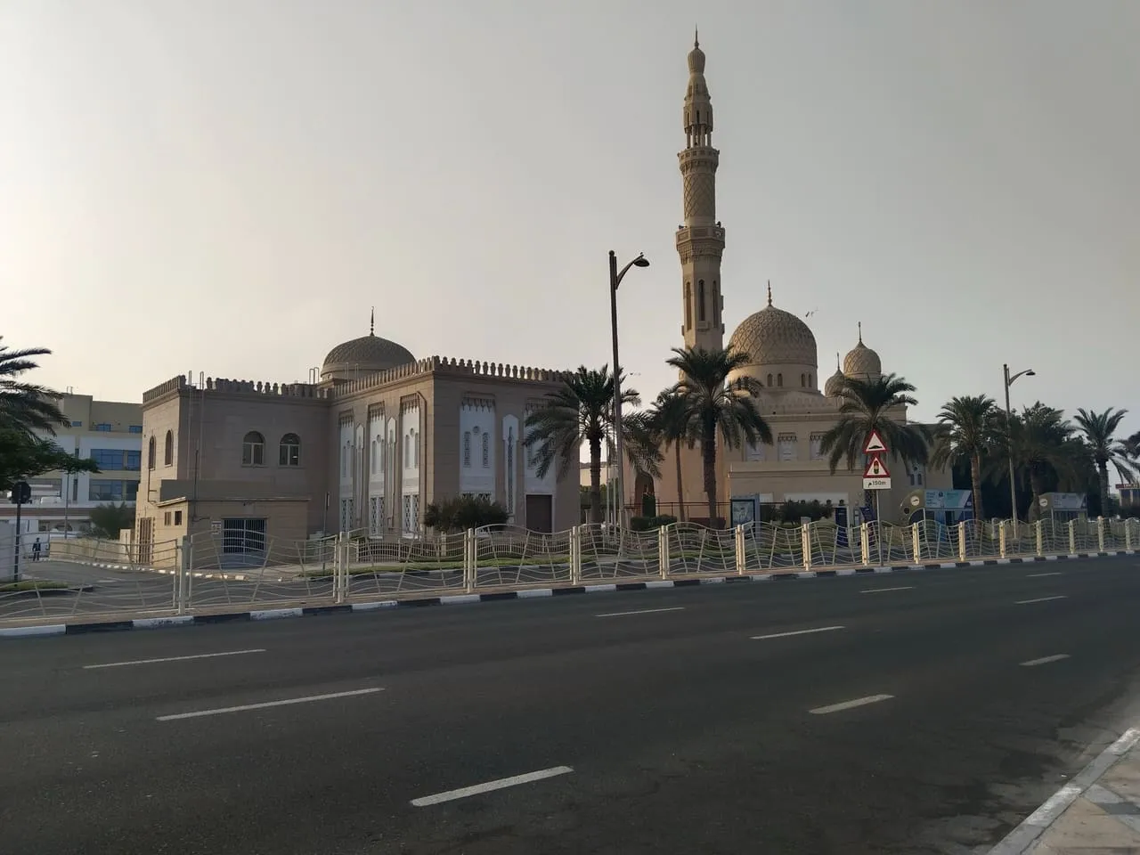 Jumeirah Mosque, with its domes and minaret, seen from the road outside