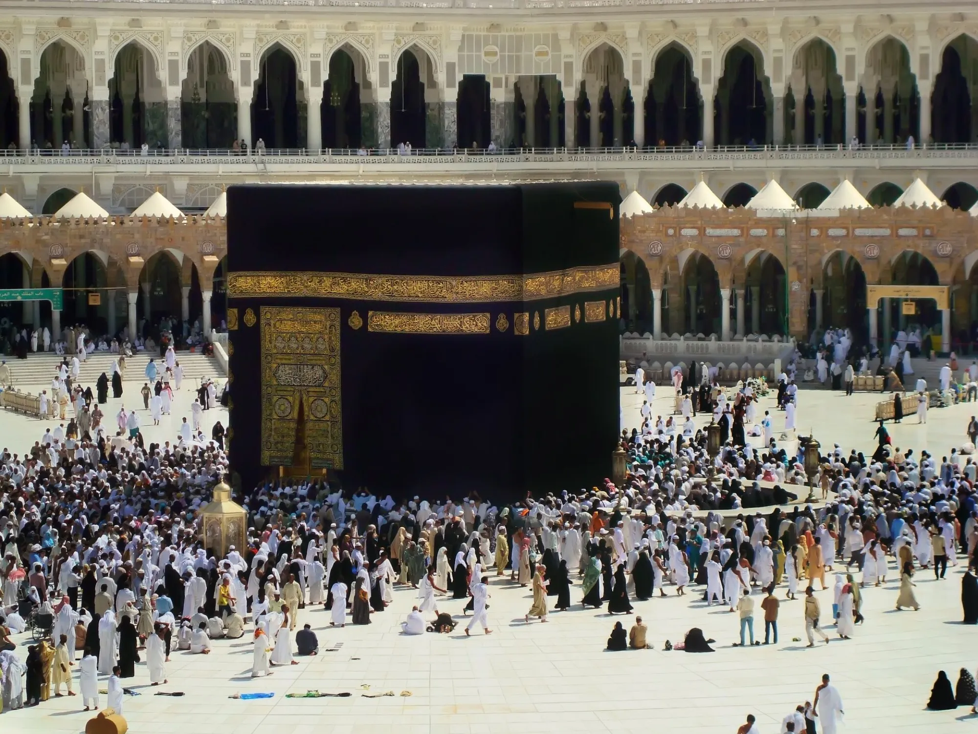 The Kaaba in the courtyard of the Masjid al-Haram in Makkah, with pilgrims walking around it
