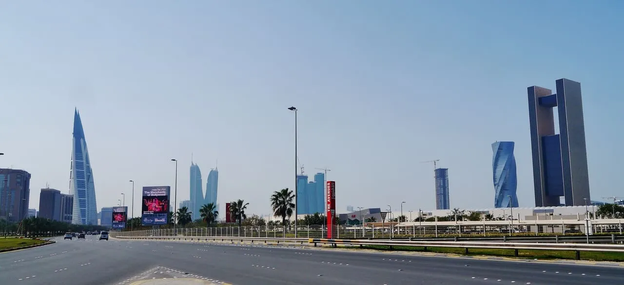 The Manama skyline from the highway, with the Bahrain World Trade Center on the left and the Four Seasons hotel at Bahrain Bay on the right