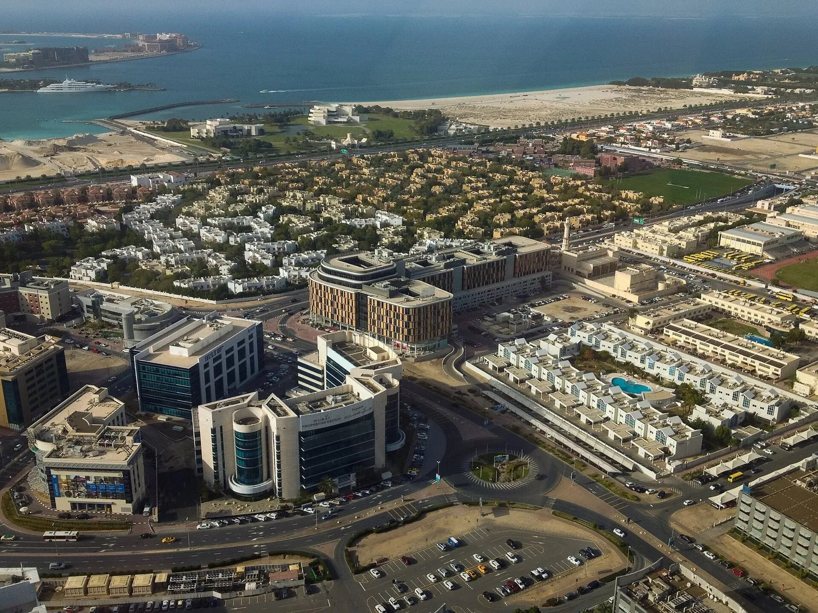 Aerial view of Dubai Media City office blocks with Jumeirah Beach and the Palm Jumeirah behind