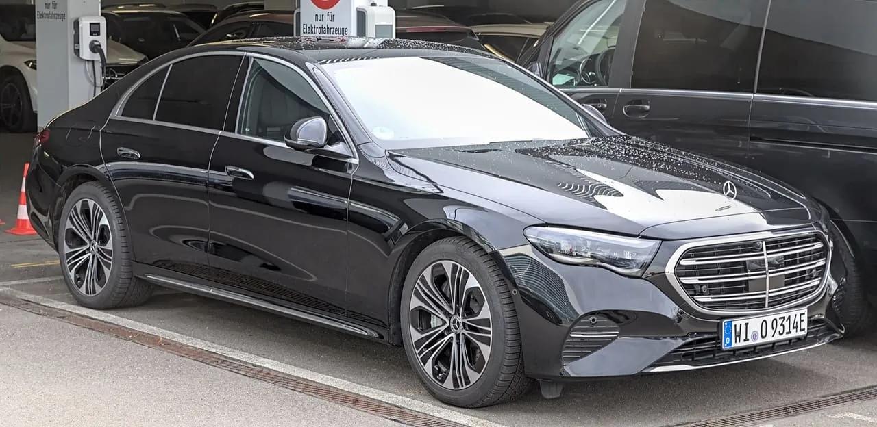 A black Mercedes-Benz E 400 e, the plug-in hybrid E-Class, parked in a garage