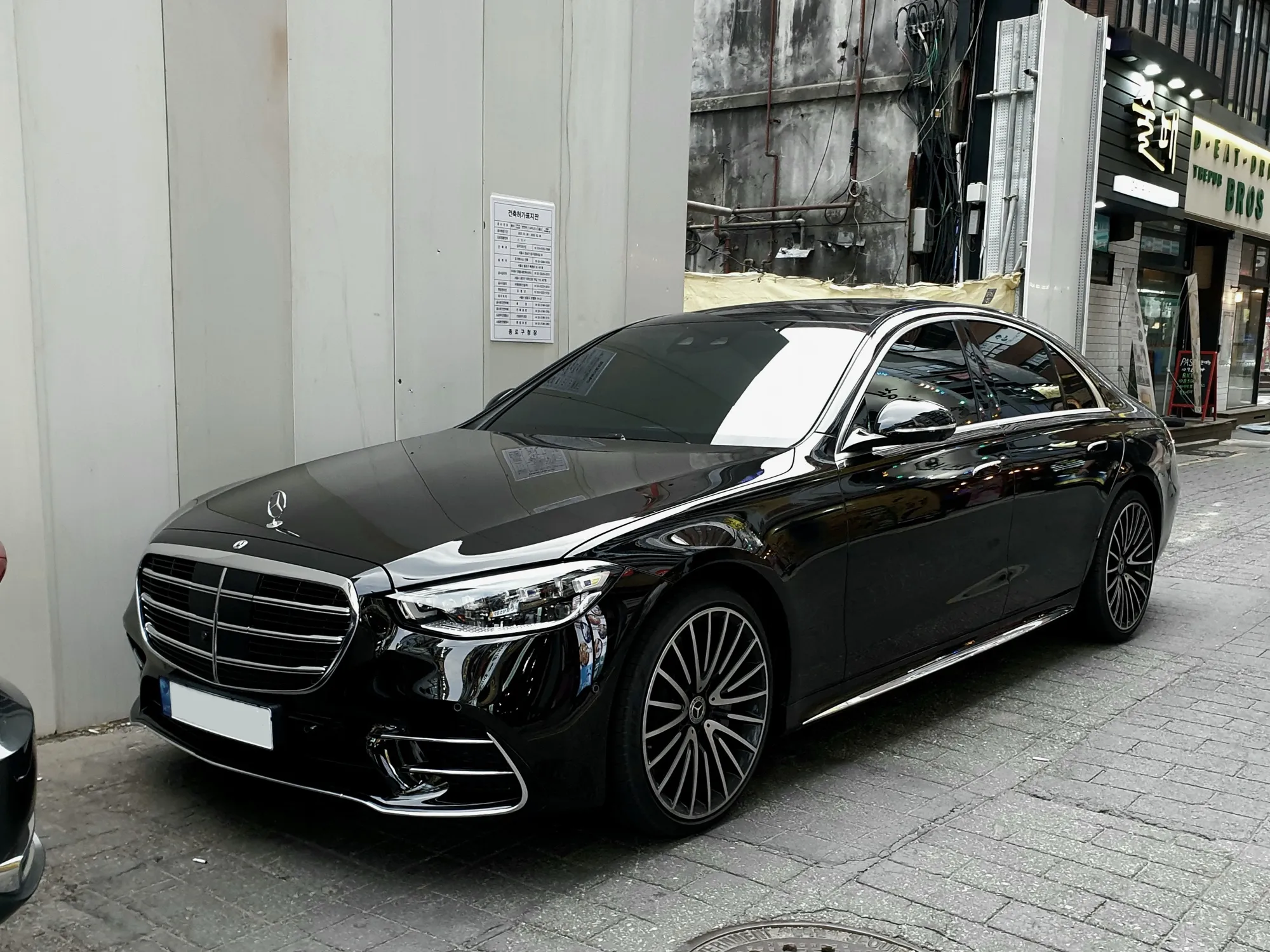 A black Mercedes-Benz S-Class saloon parked at the kerb