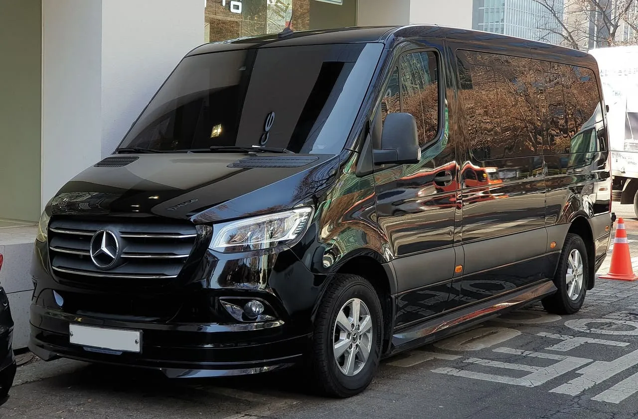 A black Mercedes-Benz Sprinter Tourer passenger van