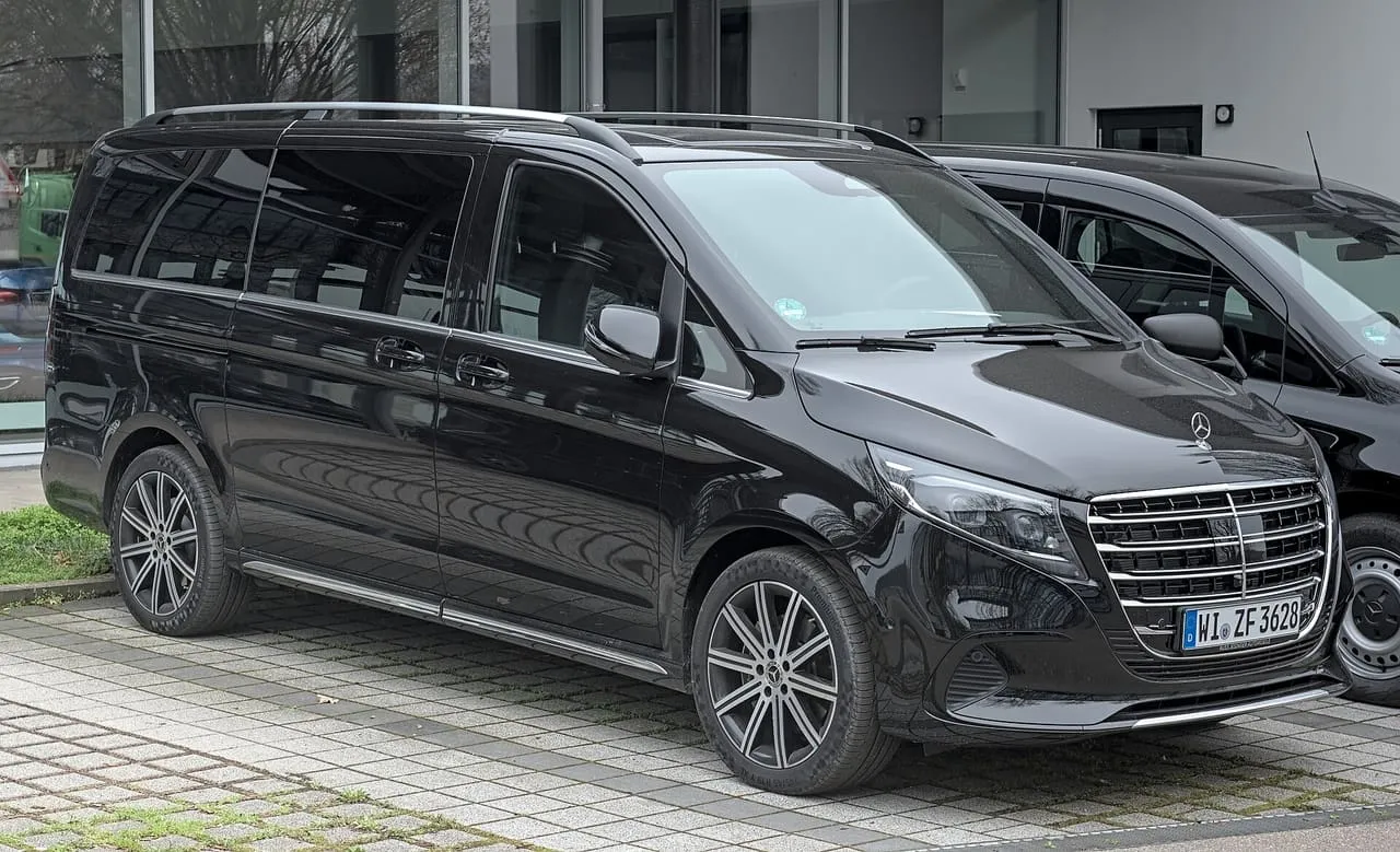 A black long-wheelbase Mercedes-Benz V-Class with sliding side doors