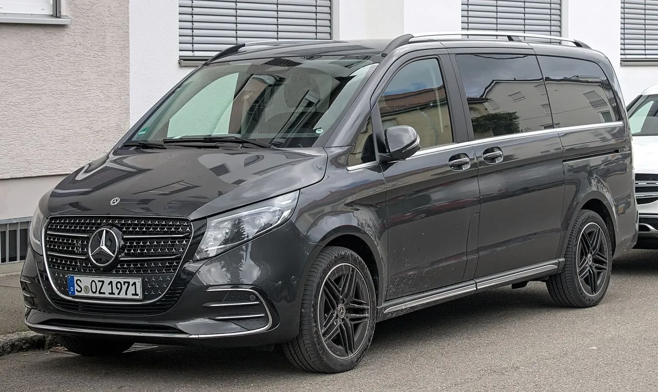 A black Mercedes-Benz V-Class people carrier with sliding side doors, parked on a street